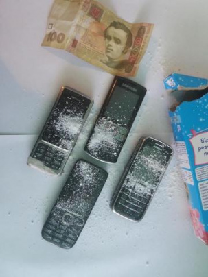 Четыре мобильных телефона в пачке стирального порошка